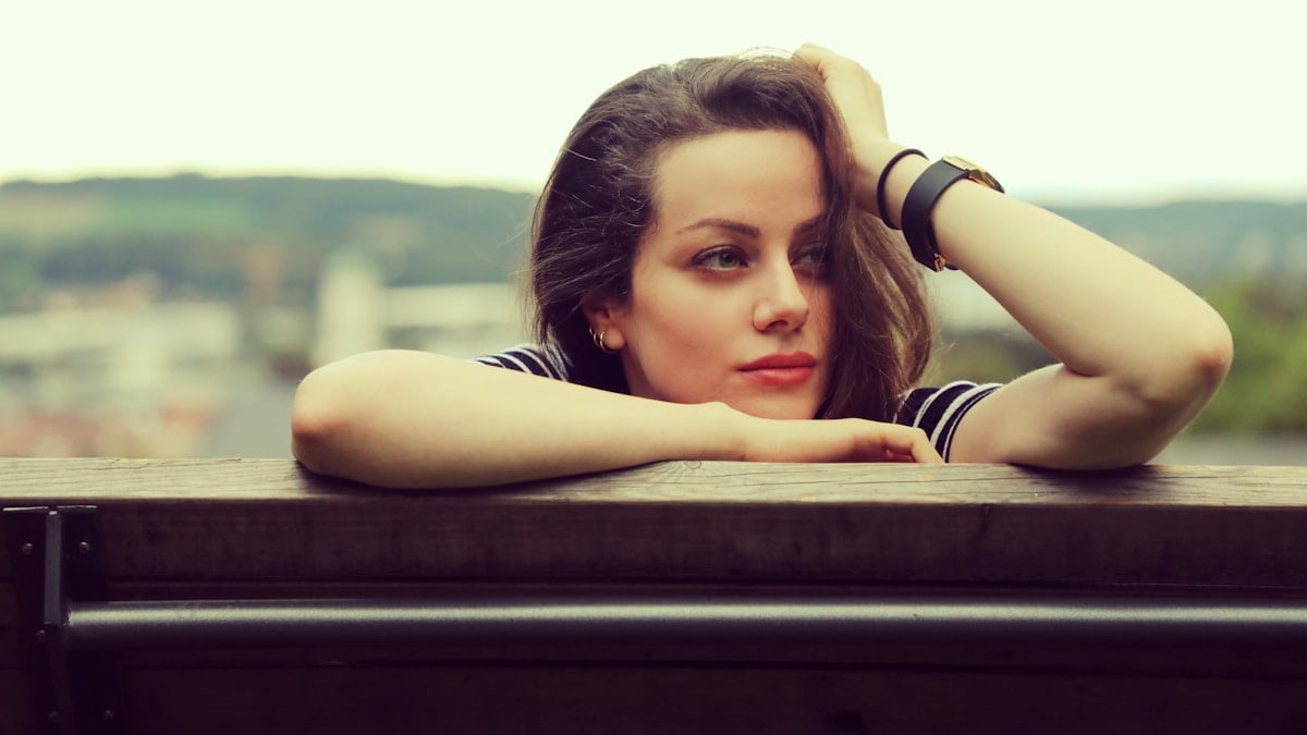 a woman lying on a bench